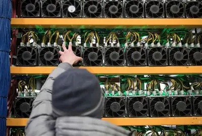A mining farm filled with rows of mining rigs, showcasing the scale of power consumption involved