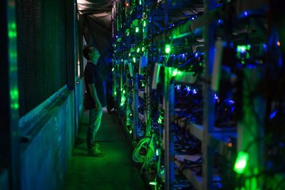 A modern mining farm with rows of mining rigs